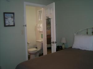 a bedroom with a bed and a bathroom with a toilet at Killington/ Rutland 2 bedroom Cabin, cabin #4 in Killington +61 photos