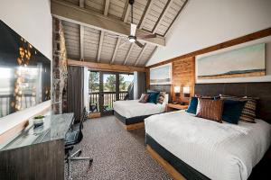 a hotel room with two beds and a desk and a desk at Sunriver Resort in Sunriver