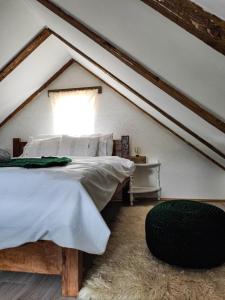 a bedroom with a bed in a attic at The Village House Zlatar in Nova Varoš