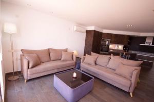 a living room with two couches and a table at Soling 65 in La Manga del Mar Menor