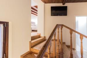 a staircase in a house with a tv on the wall at Ciasa De Gahja in Budòio
