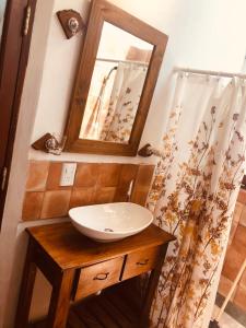 a bathroom with a sink and a mirror at Refugios del Callejón in San Carlos