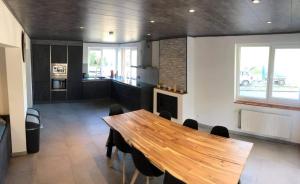 a dining room with a wooden table and a fireplace at Gîte D'han le coin in Han-sur-Lesse