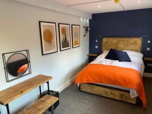 a bedroom with a bed and a wooden bench at Seven Stars Boutique Guesthouse in Exeter