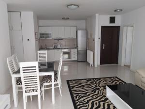 a kitchen and dining room with a table and chairs at Petar's Apartment Centar in Skopje