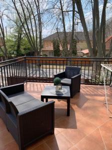 a patio with two chairs and a coffee table at Balaton Apartmanház in Siófok