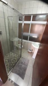 a bathroom with a glass shower with a toilet at Uvongo cabanas 5A in Margate
