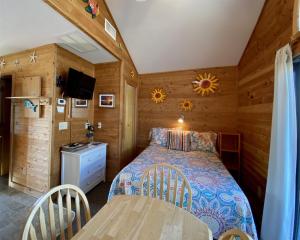 a bedroom with a bed and a table in a room at NC 12 56821-11 Condo in Hatteras