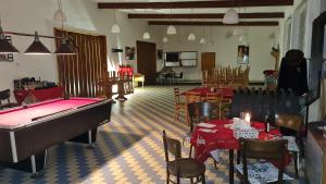 a room with a pool table and tables and chairs at Wodolenka in Hrádek