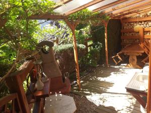 a garden room with a bench and a sink at Domek letniskowy 8 -osobowy in Sianozety