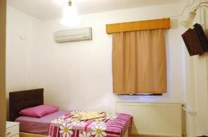 Habitación pequeña con cama y ventana en Bilsu Volley Hotel, en Cesme