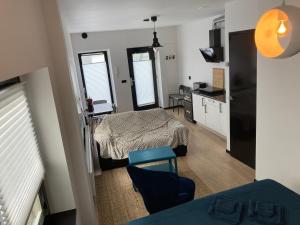 a living room with a bed and a kitchen at Dordrecht in Dordrecht