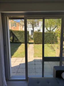 a sliding glass door with a view of a yard at Appartement rénové en duplex à proximité du centre in Le Palais +3 photos