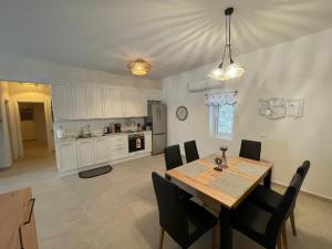 a kitchen and dining room with a table and chairs at The View Condo No2 'The Emmanuel' in Kyra Panagia