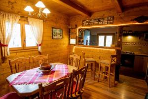 a kitchen and dining room with a table and chairs at Kuća za odmor Grunt in Veliko Trgovišće