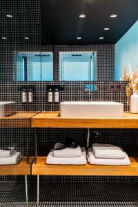 a bathroom with a sink and a counter with towels at Chambre d'Amis by Alix in Ghent