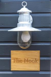 a light bulb and a sign that reads the nook at The Nook in West Mersea