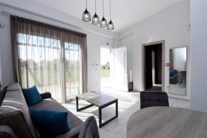 a living room with a couch and a table at GERANI apartments in Órmos