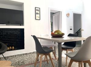 a dining room with a table and chairs and a television at Palm House 10 in Benalmádena