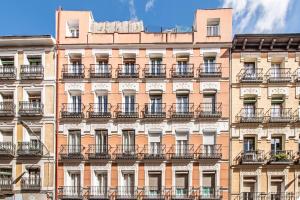 a facade of an apartment building with balconies at Charming Plaza de España Central in Madrid