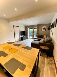 a living room with a table and a couch at 3 Sheraton Apartments in Fort William