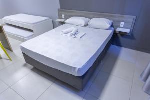 Postel nebo postele na pokoji v ubytování USEHOTEL - A uma quadra do complexo hospitalar Santa Casa
