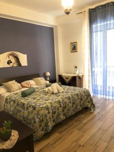 a bedroom with a bed and a table in it at B&B Antonella in Taormina