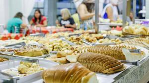 a buffet filled with different types of bread and pastries at Hotel Arterial in Foz do Iguaçu