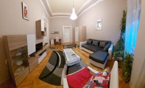 a living room with a couch and a table at Klauzál Apartment in Szeged