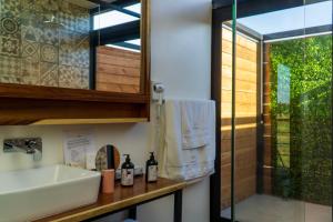 a bathroom with a sink and a shower at Xaroma in Valle de Guadalupe