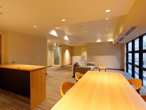 a conference room with a table and a couch at Hotel Grand Terrace Obihiro Annex in Obihiro