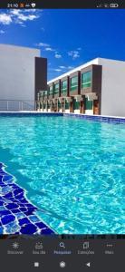 una rappresentazione di una piscina in un edificio di apartamento 2 quartos em Porto segur BA a Porto Seguro