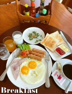 a plate of breakfast food with eggs and bread on a table at Koh Chang Bailan Beach Resort in Ko Chang