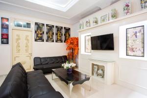 a living room with a couch and a fireplace at Griya QQ Guest House in Yogyakarta