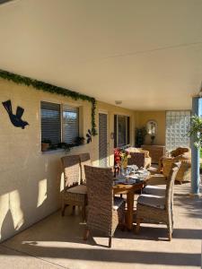 a dining table and chairs on a patio at Stella Maris in Eden