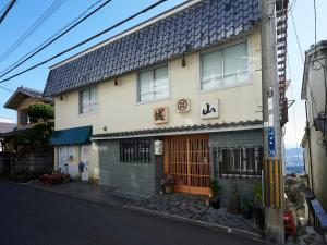 a building on the side of a street at Shiroyama Ryokan in Ikuma