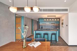 a kitchen and dining room with a blue bar at the Arca in Hong Kong
