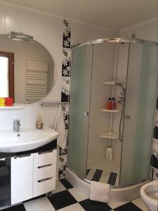 a bathroom with a shower and a sink at Mansarda Aparts in Skole