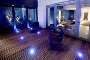 a room with a balcony with a bed and a table and chairs at Hotel C2 in Marseille
