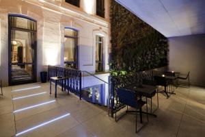 a restaurant with tables and chairs in a building at Hotel C2 in Marseille