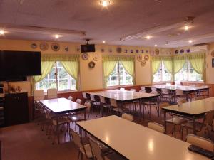 an empty dining room with tables and chairs at Pension Kaoru in Kiso