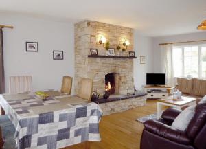 a living room with a fireplace and a table and a couch at Shannons Gate in Killorglin