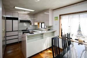 a kitchen with white cabinets and a counter top at Gairoju / Vacation STAY 2366 in Higashi-osaka