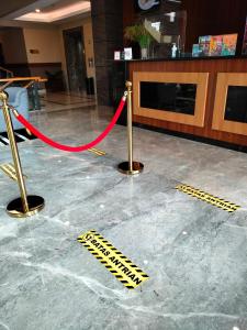a red rope on a floor in a lobby at Grand Padis Hotel in Bondowoso