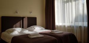 Postel nebo postele na pokoji v ubytování Hotel Dainava