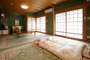 een groot bed in een kamer met ramen bij Gairoju / Vacation STAY 3715 in Higashiosaka