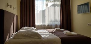 Postel nebo postele na pokoji v ubytování Hotel Dainava