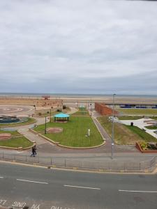 a view of a park next to the beach at Sand Beach in Rhyl