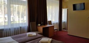 Postel nebo postele na pokoji v ubytování Hotel Dainava + 14 fotografií