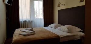 Postel nebo postele na pokoji v ubytování Hotel Dainava